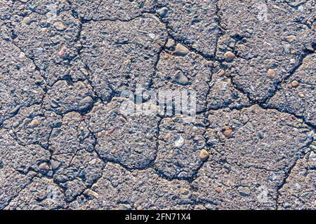 texture of cracked old road surface, background of old broken asphalt road or sidewalk Stock Photo