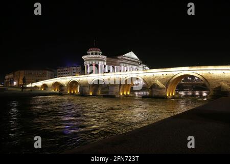 Stone Bridge, behind the Archeology Museum at night in Skopje, Macedonia. Stone Bridge is considered a symbol of Skopje. Stock Photo