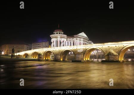 Stone Bridge, behind the Archeology Museum at night in Skopje, Macedonia. Stone Bridge is considered a symbol of Skopje. Stock Photo