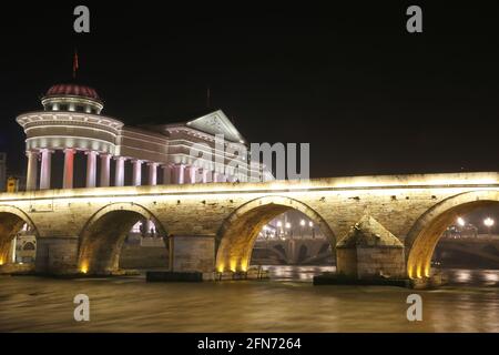 Stone Bridge, behind the Archeology Museum at night in Skopje, Macedonia. Stone Bridge is considered a symbol of Skopje. Stock Photo