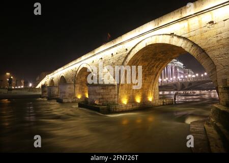 Stone Bridge, behind the Archeology Museum at night in Skopje, Macedonia. Stone Bridge is considered a symbol of Skopje. Stock Photo