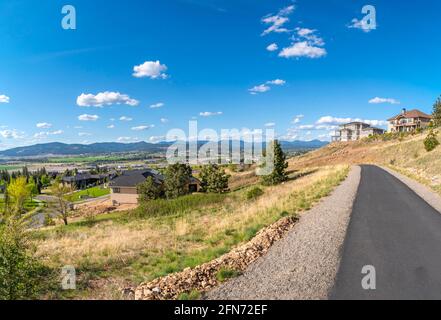 View from a concrete hiking path on the top of a hill in Liberty Lake, with new luxury homes being built overlooking the Spokane Valley, Newman Lake, Stock Photo