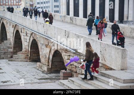 SKOPJE, MACEDONIA - DECEMBER 25: People walking at Stone Bridge in Skopje on December 25, 2016 in Macedonia. Stone bridge is considered a symbol of Skopje. Stock Photo