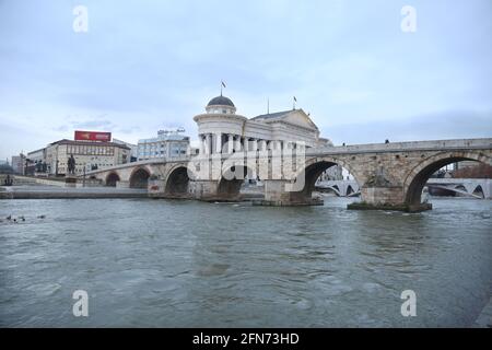 SKOPJE, MACEDONIA - DECEMBER 25: Stone Bridge and behind the Archeology Museum in Skopje on December 25, 2016 in Macedonia. Stone bridge is considered a symbol of Skopje. Stock Photo