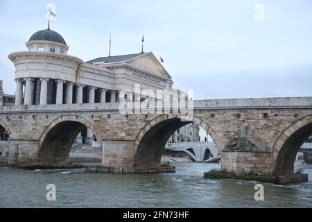 SKOPJE, MACEDONIA - DECEMBER 25: Stone Bridge and behind the Archeology Museum in Skopje on December 25, 2016 in Macedonia. Stone bridge is considered a symbol of Skopje. Stock Photo