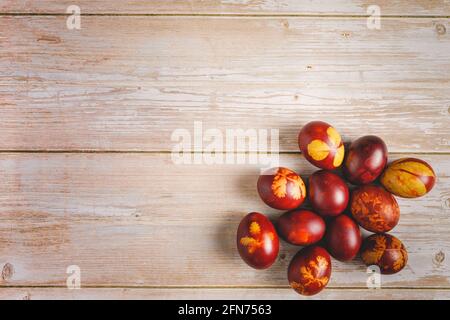 Top down flat lay view on easter eggs painted on wooden background with copy space Stock Photo