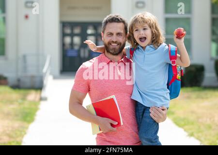 Teachers day. School boy going to school with father. Father leads a little child school boy in first grade. Stock Photo