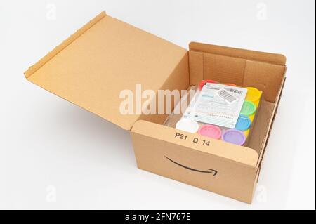 Fuji City, Shizuoka-Ken, Japan - April 29, 2021: Open cardboard box for delivery of goods from Amazon Japan. Isolated on white background. Unboxing. Stock Photo