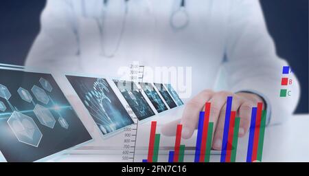 Statistical and medical data processing against mid section of doctor using digital tablet Stock Photo