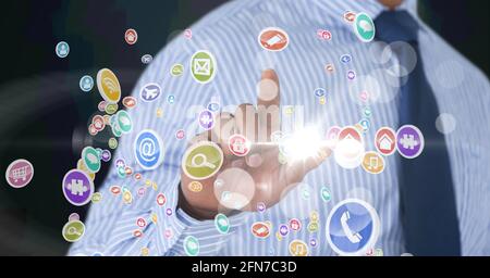 Composition of digital icons over caucasian businessman Stock Photo