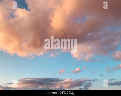 Beautiful view of pink fluffy clouds in the sky during sunset Stock Photo -  Alamy