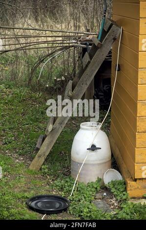 garden equipment stands near the wall, spring Stock Photo