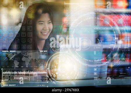 Multi exposure of Closeup Asian businesswoman hand using the laptop with digital display screen of futuristic on the desk beside the glass in workplac Stock Photo