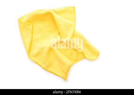 Yellow kitchen rug isolated on white. Crumpled used microfiber cloth clean, top view. Stock Photo