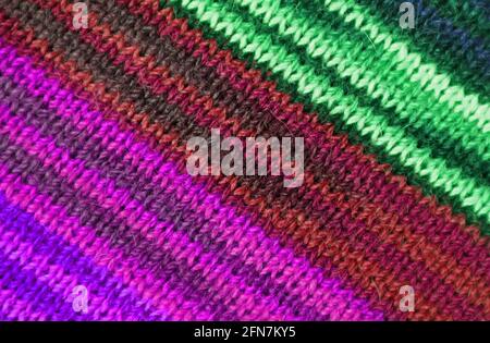 Green and Purple Tone Striped Alpaca Knitted Wool Fabric Texture in Diagonal Patterns for Abstract Background Stock Photo