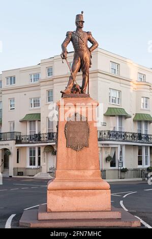 EASTBOURNE, EAST SUSSEX, UK - APRIL 30, 2012:  War memorial with bronze statue of a soldier of the Royal Sussex Regiment on Grand Parade Stock Photo