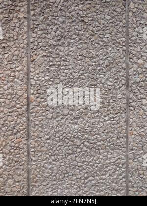 Granulated stone wall texture with a vertical parting line Stock Photo