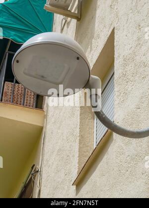 Modern led streetlight installed in an old style Spanish neighborhood Stock Photo