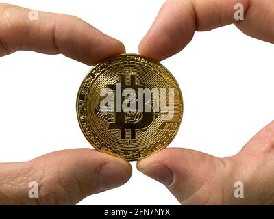 Golden Bitcoin coin in man's hands isolated on white background Stock Photo