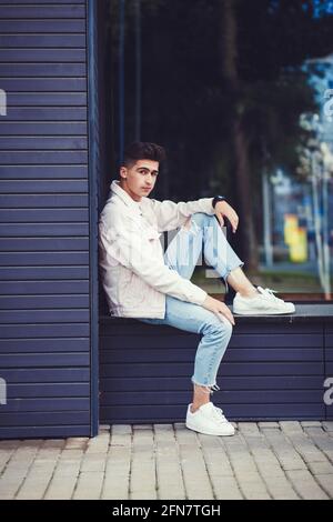 Young Trendy Modern Hipster Male Model Poses in Denim Jacket and Brimmed  Hat on Top of Parking Garage Stock Photo | Adobe Stock