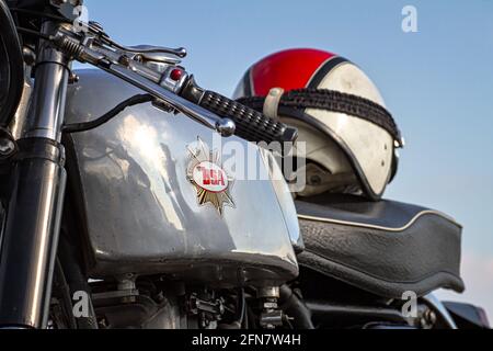 Closeup Of The Clubman Steel Tank And BSA Badge Of A 1960s BSA Goldstar DBD34 With Crash Helmet On Seat UK Stock Photo