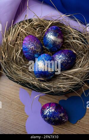 Vertical shot of blue decorated eggs in a nest Stock Photo