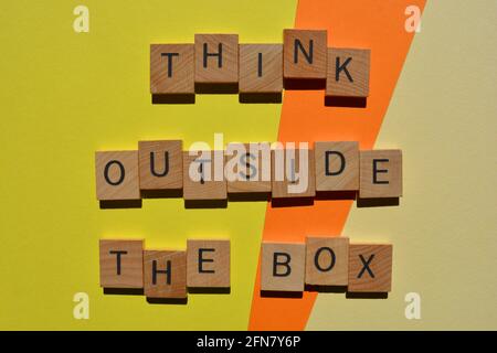 Think Outside The Box, inspirational words in wooden letters on colourful background Stock Photo