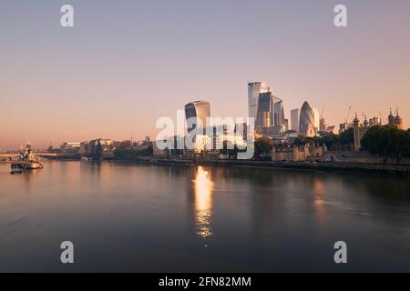 View of riverbank Thames River against skyscrapers. Urban skyline of London at morning light , United Kingdom. Stock Photo