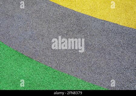 Yellow gray and green outdoor rubber mat background. Children playground. Colorful Sports Court Background. Top View Stock Photo