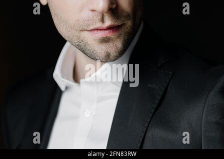 Young business man posing, isolated over black background Stock Photo