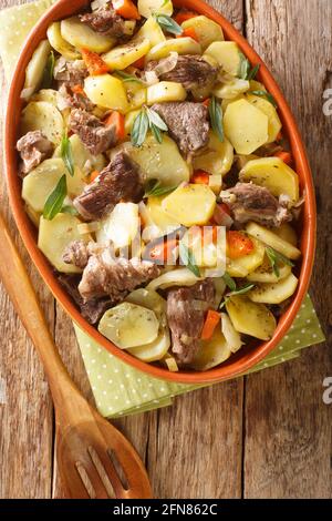 Baeckeoffe is a casserole dish a mix of sliced potatoes, onions, mutton, beef, and pork which have been marinated in Alsatian white wine closeup in th Stock Photo