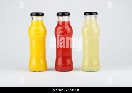 Glass fruit juice bottle isolated on white background. Stock Photo