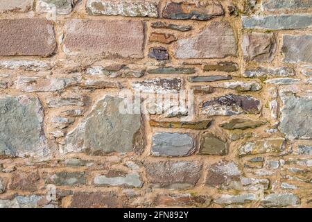 Old stone wall abstract background, with cement filling Stock Photo