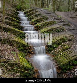 A manmade waterfall in Haigh Woodlands Park, Haigh Plantations, Wigan, Greater Manchester. Stock Photo