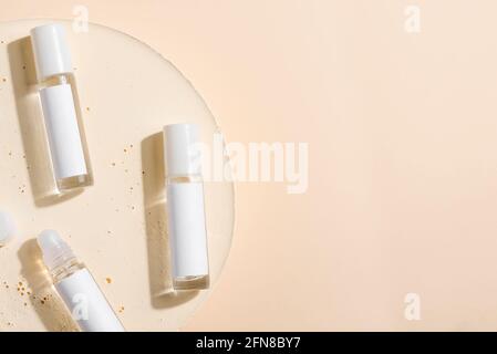 glass product package perfume samples on beige background Stock Photo