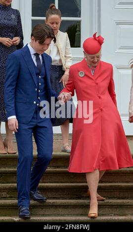 Prince Christian helps 'grand-mother' Queen Margrethe Crownprince Family in back during Prince Christian’s confirmation at Fredensborg Palace Church in Denmark on May 15, 2021. Photo by Stefan Lindblom/Stella Pictures/ABACAPRESS.COM Stock Photo