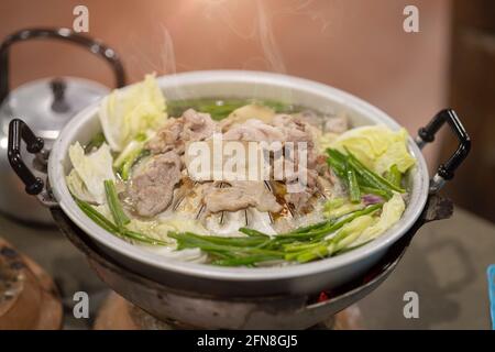 Thai style pork pan BBQ grill with vegetable soup called Moo-Ka-Ta. Stock Photo