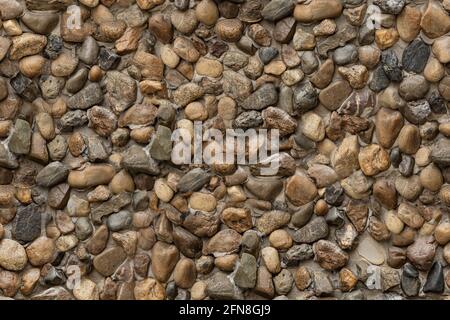 seamless texture of stone wall river rock pattern nature background. Stock Photo