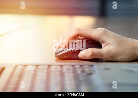 Close up of business woman hand using mouse with computer laptop for working in office. Stock Photo