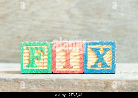 Color alphabet letter block in word fix on wood background Stock Photo