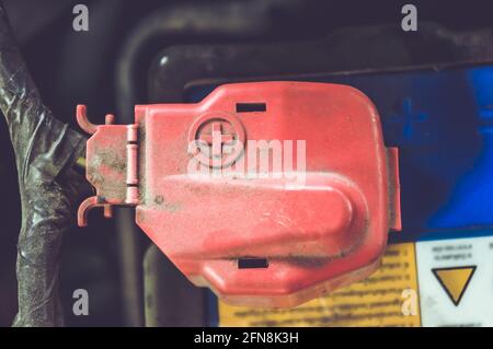 Closeup at red terminals battery in the engine room. Good arrangement for safety and warning signs on the top cover. Stock Photo