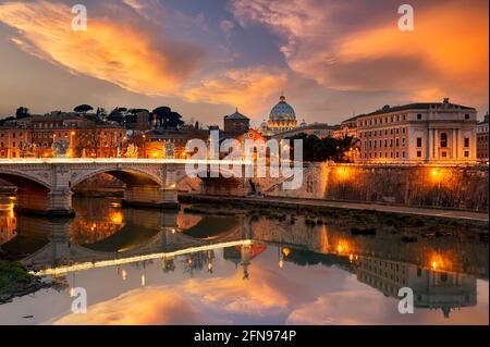 View of the Tiber River and Saint Peter's Basilica at sunset in Rome Italy
