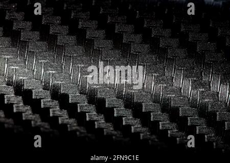 Black patterned textured background for design purpose. Ultra Glossy Carbon Fiber Vinyl Car Wrap Stock Photo