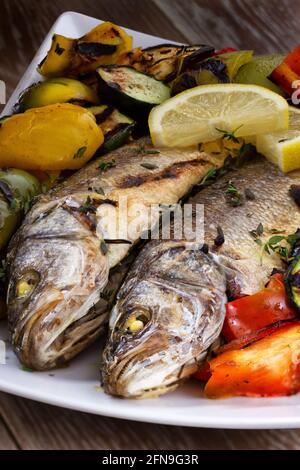 Sea bass with grilled vegetables. High quality photo. Stock Photo