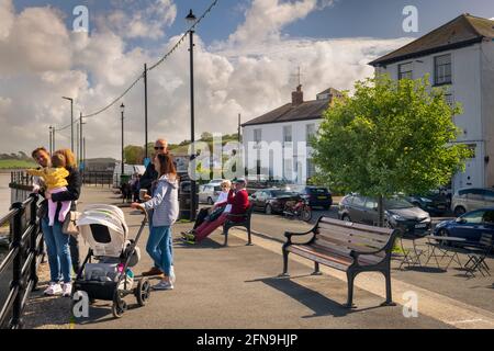 North Devon, UK. May 15 2021: UK Weather -  Ahead of the Covid rules being relaxed on Monday 17th, on a sunny day with a gentle breeze in North Devon, tourists to the small coastal village of Appledore enjoy the afternoon sunshine on the quay. Terry Mathews/Alamy Live News. Stock Photo