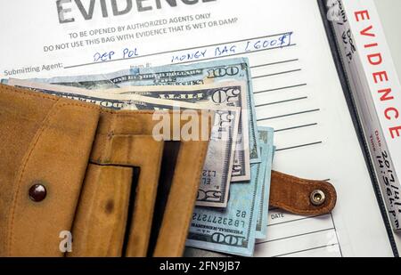 Some hundred dollar notes in a wallet in a crime lab, concept image Stock Photo