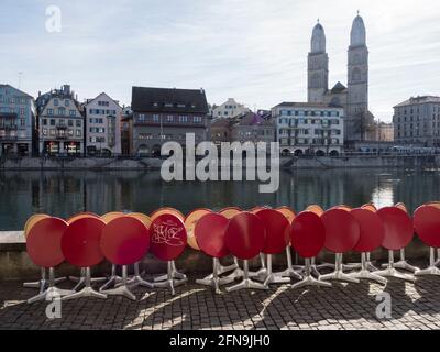 Outside cafe tables are folded away in front of a restaurant that is closed due to Covid lockdown at downtown Zurich on a sunny spring day. Stock Photo