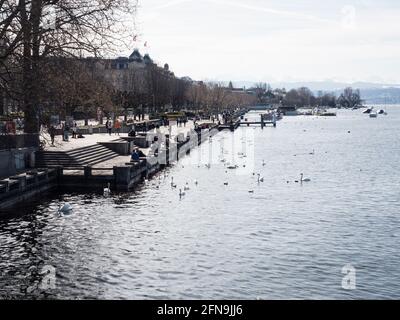 Lake Zurich and the lakefront around Zurich Bellevue on a bright sunny winter day. Stock Photo