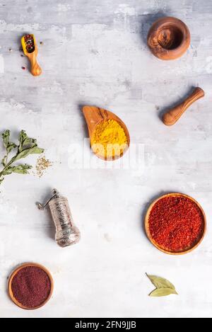 kinds of spices of different grinding in wooden bowl with handle grinder on stone , flat lay Stock Photo