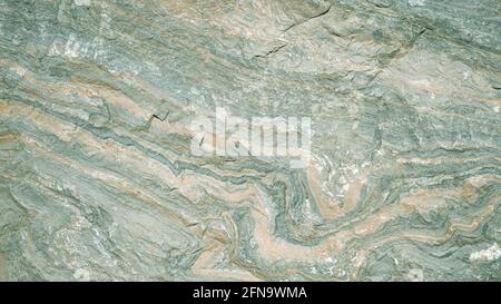 The texture of the stone is green with orange streaks. Background. Stock Photo